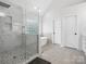 Modern bathroom featuring a glass shower with stone accents and a freestanding soaking tub at 8921 Whittingham Dr, Waxhaw, NC 28173