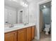 Bathroom with a double sink vanity and a separate toilet area with a shower at 8921 Whittingham Dr, Waxhaw, NC 28173