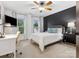 Comfortable bedroom with a ceiling fan, a large window, and a desk for working or studying at 8921 Whittingham Dr, Waxhaw, NC 28173