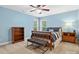Blue bedroom features a ceiling fan, a large window, and a cozy bed with stylish striped bedding at 8921 Whittingham Dr, Waxhaw, NC 28173