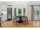Cozy dining area featuring a chandelier, large windows, and a stylish table set for a meal at 8921 Whittingham Dr, Waxhaw, NC 28173