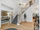 Inviting foyer with hardwood floors and a staircase with an adjacent living area at 8921 Whittingham Dr, Waxhaw, NC 28173