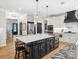 Open-concept kitchen featuring a large island, modern appliances, and dark wood accents for contrast at 8921 Whittingham Dr, Waxhaw, NC 28173