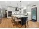 Gourmet kitchen boasting a large island with seating, stainless steel appliances, and sleek white cabinets at 8921 Whittingham Dr, Waxhaw, NC 28173