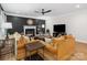 Comfortable living room with hardwood floors, fireplace, stylish sofas, and a ceiling fan for added air circulation at 8921 Whittingham Dr, Waxhaw, NC 28173