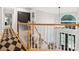 Elegant staircase with wooden railings and a black and white patterned rug at 8921 Whittingham Dr, Waxhaw, NC 28173