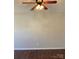Living room featuring hardwood flooring, ceiling fan with lighting, and neutral paint at 9170 Bradstreet Commons Way, Charlotte, NC 28215