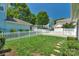 Well-maintained backyard featuring lush grass and a charming white picket fence at 9227 Island Overlook Ct, Cornelius, NC 28031
