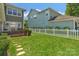 Expansive backyard offers a patio, a grassy area, and a classic white picket fence at 9227 Island Overlook Ct, Cornelius, NC 28031