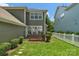 Beautiful backyard with a small deck, landscaping, and a classic white picket fence at 9227 Island Overlook Ct, Cornelius, NC 28031