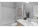 Full bathroom featuring a shower-tub combo, a framed mirror, and neutral colored cabinets at 9227 Island Overlook Ct, Cornelius, NC 28031