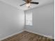 Empty bedroom featuring hardwood floors, neutral walls, ceiling fan, and a window at 9227 Island Overlook Ct, Cornelius, NC 28031