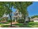 Beautiful exterior view of a two-story home with trees in a well-maintained landscape at 9227 Island Overlook Ct, Cornelius, NC 28031