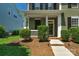 Charming front exterior with a cozy porch and manicured landscaping for great curb appeal at 9227 Island Overlook Ct, Cornelius, NC 28031