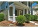Inviting front porch featuring elegant columns and beautiful landscaping for added curb appeal at 9227 Island Overlook Ct, Cornelius, NC 28031