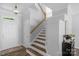Bright entryway showcasing staircase with wood and white accents and a modern light fixture at 9227 Island Overlook Ct, Cornelius, NC 28031