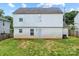 Home's backyard features a well-maintained lawn and a white siding exterior at 9612 Old Dowd Rd, Charlotte, NC 28214