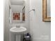 Bathroom with pedestal sink and decorative mirrors at 9612 Old Dowd Rd, Charlotte, NC 28214