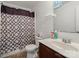 Cozy bathroom with patterned shower curtain and a dark vanity at 9612 Old Dowd Rd, Charlotte, NC 28214