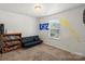 Bedroom features a built-in bookcase and a cozy futon for relaxing at 9612 Old Dowd Rd, Charlotte, NC 28214
