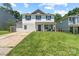 Charming two-story home with blue shutters and well-manicured lawn at 9612 Old Dowd Rd, Charlotte, NC 28214