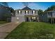Charming two-story home with blue shutters and well-manicured lawn at 9612 Old Dowd Rd, Charlotte, NC 28214