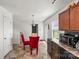 Eat-in kitchen features dark cabinets, black appliances, and space for a breakfast table at 9612 Old Dowd Rd, Charlotte, NC 28214