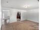 Spacious living room with neutral carpet flowing into the kitchen area at 9612 Old Dowd Rd, Charlotte, NC 28214