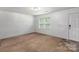 Bright and airy living room features neutral carpet and natural light at 9612 Old Dowd Rd, Charlotte, NC 28214
