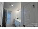 Bright bathroom with double sinks, gray tiled floors and tiled shower with glass door at 102 Cartington Way # Haf0042, Mooresville, NC 28115