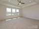 A bright bedroom with tray ceiling features three large windows offering lots of natural light and neutral carpeting at 102 Cartington Way # Haf0042, Mooresville, NC 28115