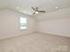 A cozy bedroom with neutral carpet has a single window and overhead lighting creating a comfortable retreat at 102 Cartington Way # Haf0042, Mooresville, NC 28115