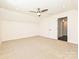 A well-lit carpeted bedroom features a ceiling fan and access to other areas of the home at 102 Cartington Way # Haf0042, Mooresville, NC 28115