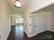 Open entryway featuring dark hardwood floors, bright white walls, and an office space perfect for modern living at 102 Cartington Way # Haf0042, Mooresville, NC 28115