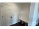 Clean entryway with a white door, bench with coat hooks, and dark hardwood floors at 102 Cartington Way # Haf0042, Mooresville, NC 28115