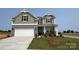 Charming two-story home featuring a brick and gray facade, well-manicured lawn, and a spacious two-car garage at 102 Cartington Way # Haf0042, Mooresville, NC 28115