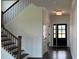 Welcoming foyer with hardwood floors, a staircase with iron railings, and a view of the front door at 102 Cartington Way # Haf0042, Mooresville, NC 28115