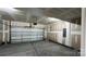 Spacious garage with a white door, gray flooring, and unfinished walls and ceiling at 102 Cartington Way # Haf0042, Mooresville, NC 28115