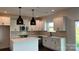 Bright kitchen featuring white cabinetry, stainless steel appliances, a center island, and neutral backsplash at 102 Cartington Way # Haf0042, Mooresville, NC 28115
