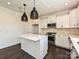 Stylish kitchen featuring white cabinetry, stainless steel appliances, a kitchen island and modern pendant lighting at 102 Cartington Way # Haf0042, Mooresville, NC 28115