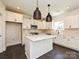 Modern kitchen with white cabinets, an island with quartz countertops, and pendant lighting, blending style with functionality at 102 Cartington Way # Haf0042, Mooresville, NC 28115