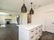 White kitchen island featuring a white countertop and storage in a spacious open-concept layout at 102 Cartington Way # Haf0042, Mooresville, NC 28115