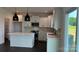 Modern kitchen with white cabinets, stainless steel appliances, a center island, and stylish pendant lighting at 102 Cartington Way # Haf0042, Mooresville, NC 28115