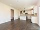 Bright, open kitchen with white cabinetry, dark wood floors, and modern pendant lighting at 102 Cartington Way # Haf0042, Mooresville, NC 28115