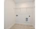 Simple laundry room with tile floors and wire shelving at 102 Cartington Way # Haf0042, Mooresville, NC 28115