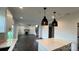 Spacious living room flows from kitchen with dark wood floors and fireplace with modern finishes at 102 Cartington Way # Haf0042, Mooresville, NC 28115