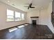 Bright living room with a stone fireplace, large windows, and natural light at 102 Cartington Way # Haf0042, Mooresville, NC 28115