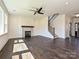 Living room with fireplace, staircase, and open layout with hardwood floors at 102 Cartington Way # Haf0042, Mooresville, NC 28115