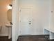 A welcoming mudroom features a pedestal sink, a door, and a convenient bench with hooks for coats and bags at 102 Cartington Way # Haf0042, Mooresville, NC 28115