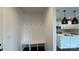 Mudroom with white bench seating, hooks, and view of the kitchen area at 102 Cartington Way # Haf0042, Mooresville, NC 28115